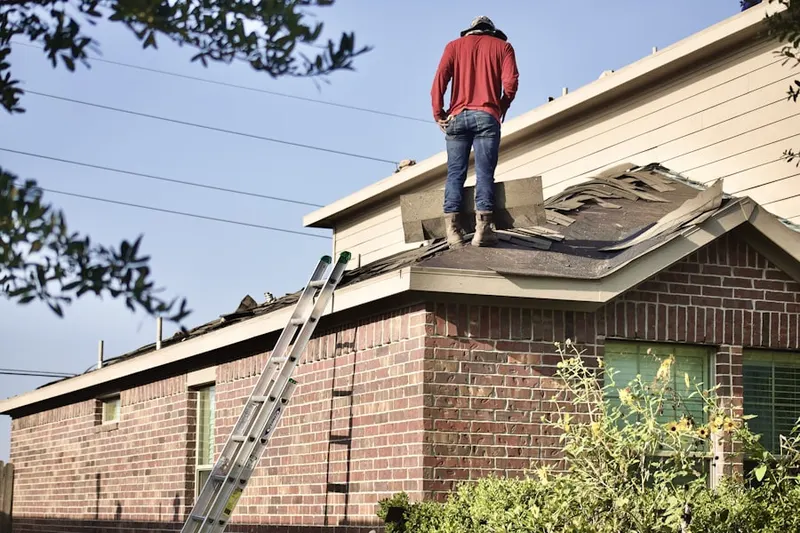 Professional roofer working on a residential roof in Gunnerville